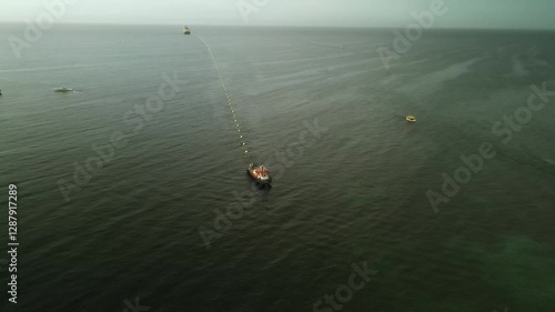 Fiber optic cable installation off Margarita Island, Venezuela, with boats and teamwork photo