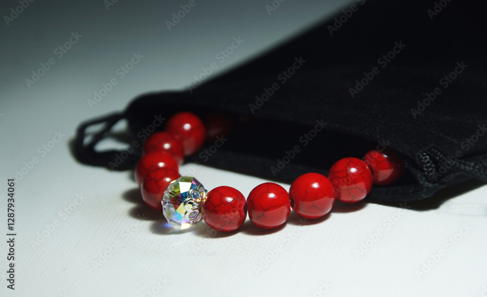 Exclusive red howlite bracelet with crystal in a black pouch