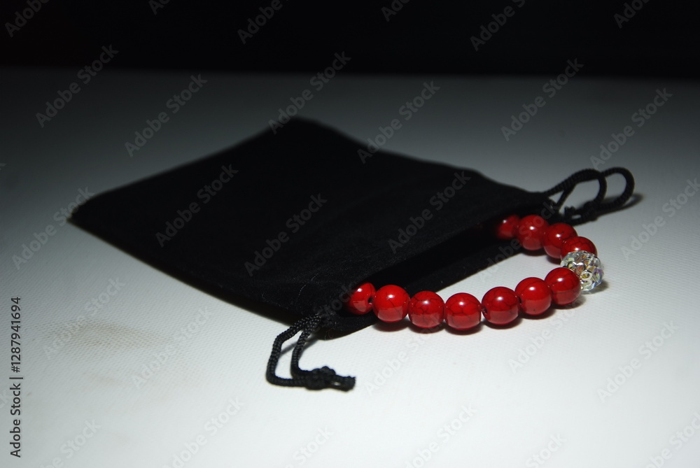 Bracelet in a black jewelry pouch. Exclusive red howlite bracelet with crystal
