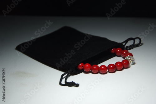 Obraz na płótnie Bracelet in a black jewelry pouch. Exclusive red howlite bracelet with crystal w salonie