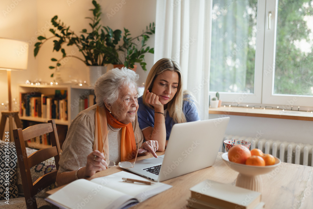 Social worker helping elderly lady with managing her finances, teaching her to use online banking on laptop. Social worker helping elderly lady with managing her finances, teaching her to use online banking on laptop.