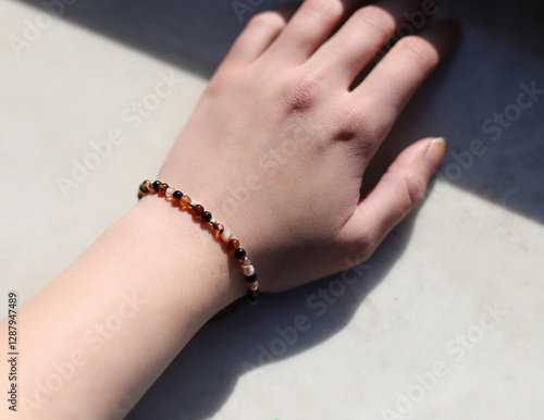 Bracelet Made of Natural Amber on a Woman's Hand