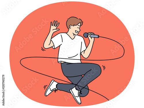 Jumping male singer with microphone enjoys performing energetic songs at karaoke party. Popular singer performing at concert and smiling while singing solo pop or hip hop composition.
