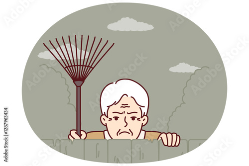 Elderly envious man neighbor peeps from behind fence spying on residents of private house. Envious male pensioner with rake looking at screen suspiciously for bad neighborhood concept.