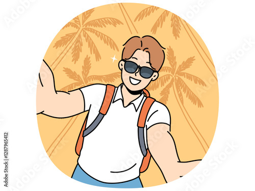 Man tourist in sunglasses takes selfie traveling to hot resort or sunny beach with palm trees. Young guy tourist with backpack smiles photographing himself for blog about vacation trip