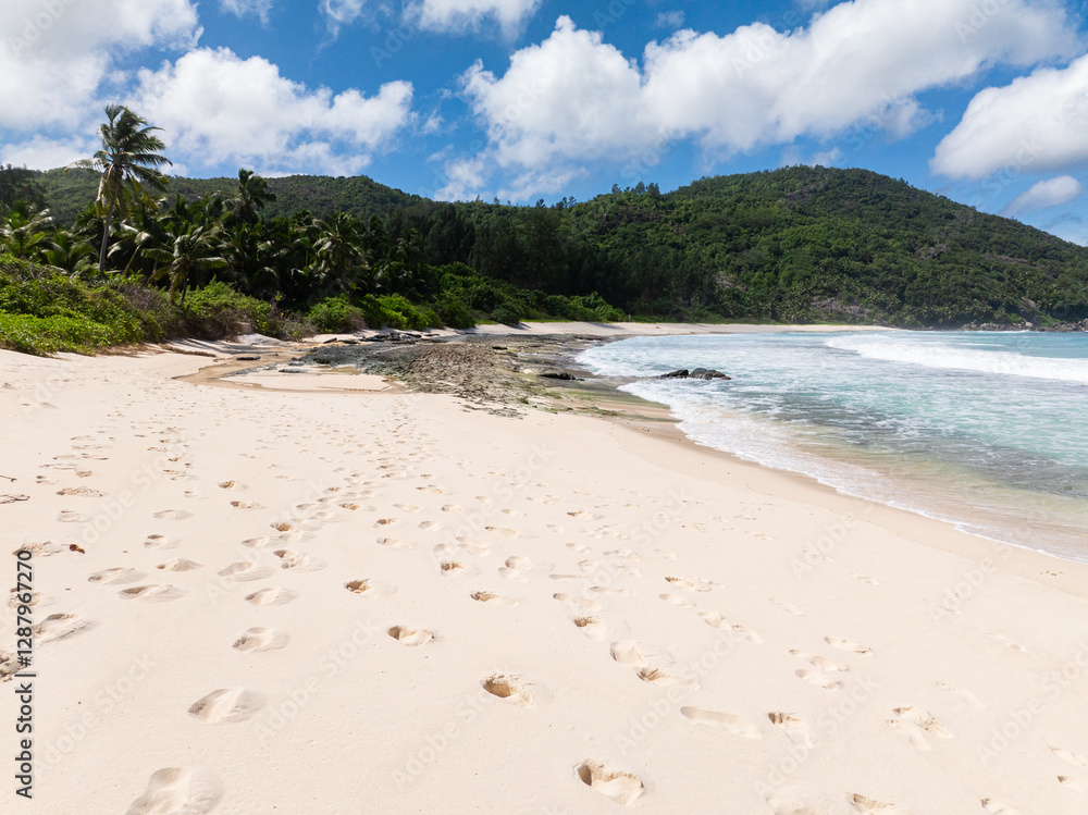 Tropical sandy beach and blue ocean in Seychelles. Police Bay beach. Tropical sandy beach and blue ocean in Seychelles. Police Bay beach.
