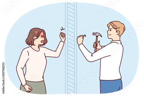 Angry woman knocks on wall swearing at neighbor is doing repairs in apartment and using hammer. Nervous girl quarreling with neighbor hammering nails because of noise caused by renovation