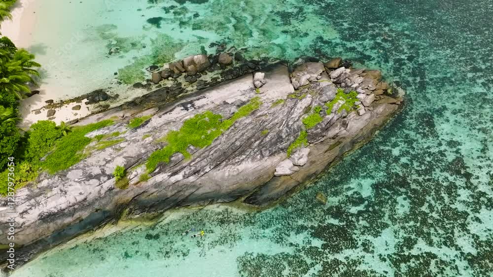 A unique rocky coastal formation surrounded by turquoise waters and fringed with greenery. Seychelles, Mahe. Anse Forbans. A unique rocky coastal formation surrounded by turquoise waters and fringed with greenery. Seychelles, Mahe. Anse Forbans.