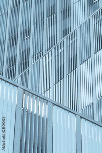 Wallpaper Mural Close-up of a contemporary glass and metal facade with vertical lines and reflections, emphasizing modern urban design. Torontodigital.ca