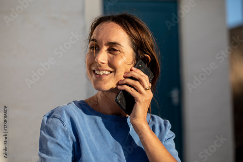 Portrait of a pretty, dark-haired woman, talking on the phone