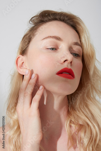 Portrait of young blond woman with red lips photo