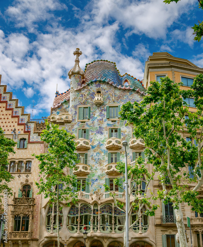 Facade of Casa Batll? with organic shapes, colorful mosaic tiles, and unique window designs in Barcelona