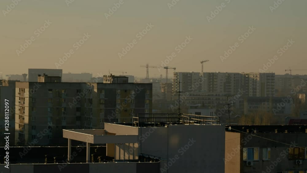 Explore the rooftops of Bucharest with stunning views of residential buildings, cranes, and the city's unique skyline during early morning light. Explore the rooftops of Bucharest with stunning views of residential buildings, cranes, and the city's unique skyline during early morning light.