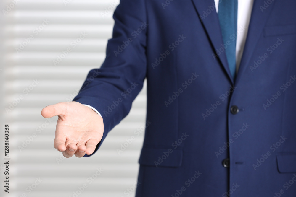 Fototapeta premium Man offering helping hand on light background, closeup