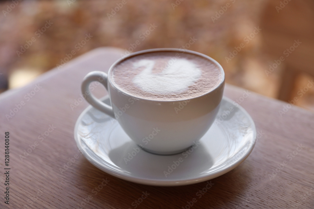 Fototapeta premium Cup of aromatic coffee on wooden table in cafe, closeup