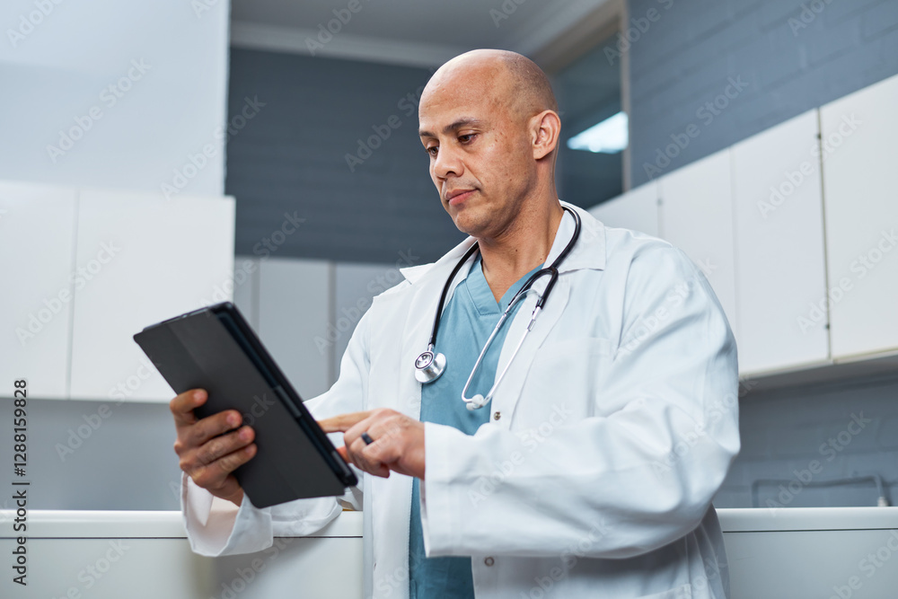 Professional Doctor in Lab Coat Using a Tablet Device in a Medical Office