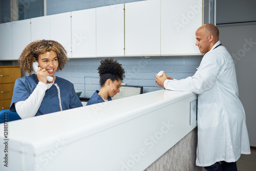 Healthcare Professionals Collaborating at a Modern Office Front Desk in a Clinical Setting