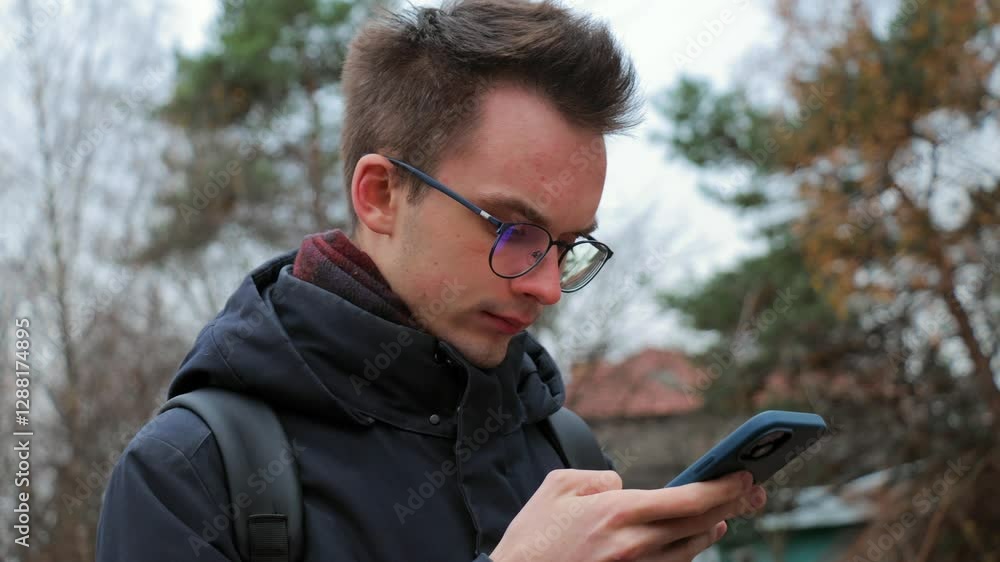 Young man using smartphone outdoors Young man using smartphone outdoors