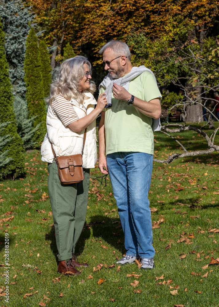 Elderly beautiful married couple on a walk in an autumn park Elderly beautiful married couple on a walk in an autumn park