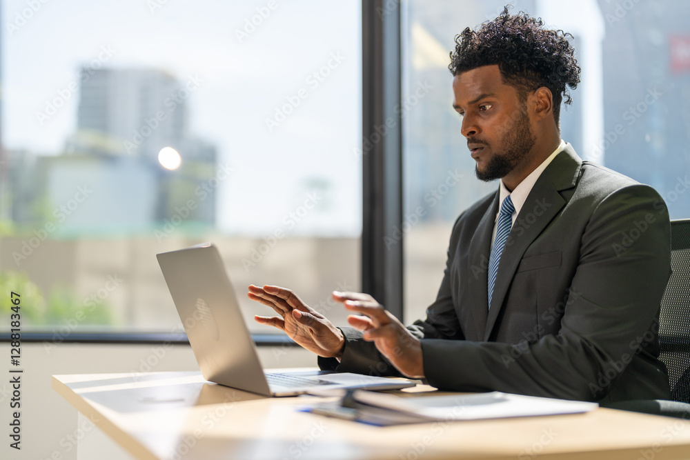 Businessman working on laptop in office, professional african american man in blue shirt corporate environment, business strategy, technology use, modern workspace, productivity and dedication Businessman working on laptop in office, professional african american man in blue shirt corporate environment, business strategy, technology use, modern workspace, productivity and dedication