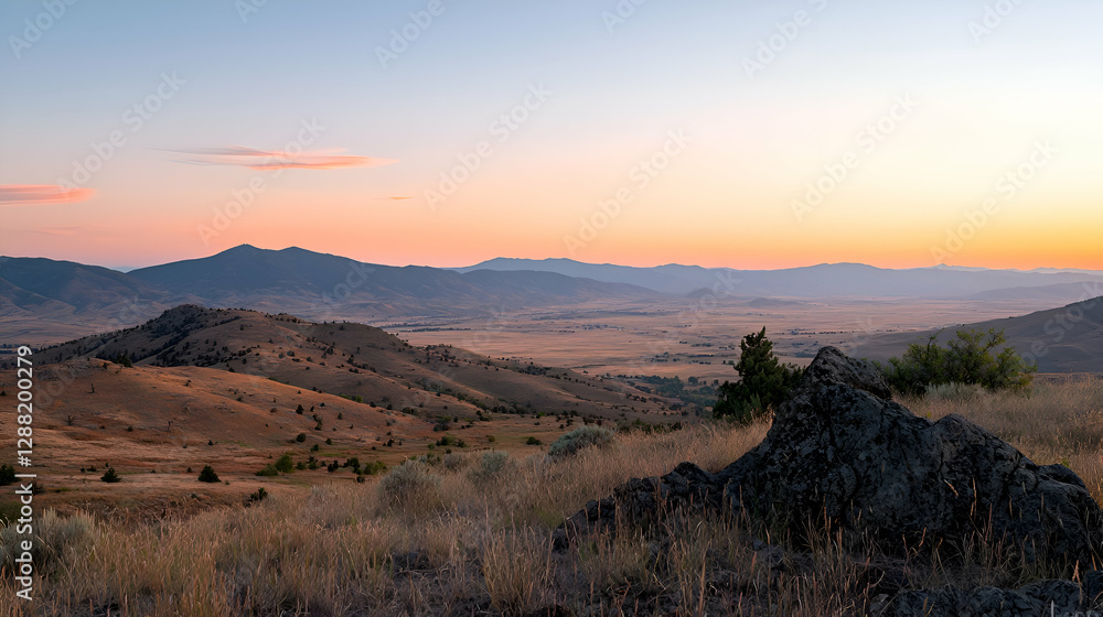 Naklejka premium Sunset Over Rolling Hills and Distant Mountains