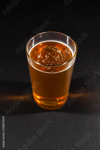 Obraz na płótnie beer mug filled with foamy amber beer is positioned to the left on a black chalkboard background, leaving empty space on the right w salonie