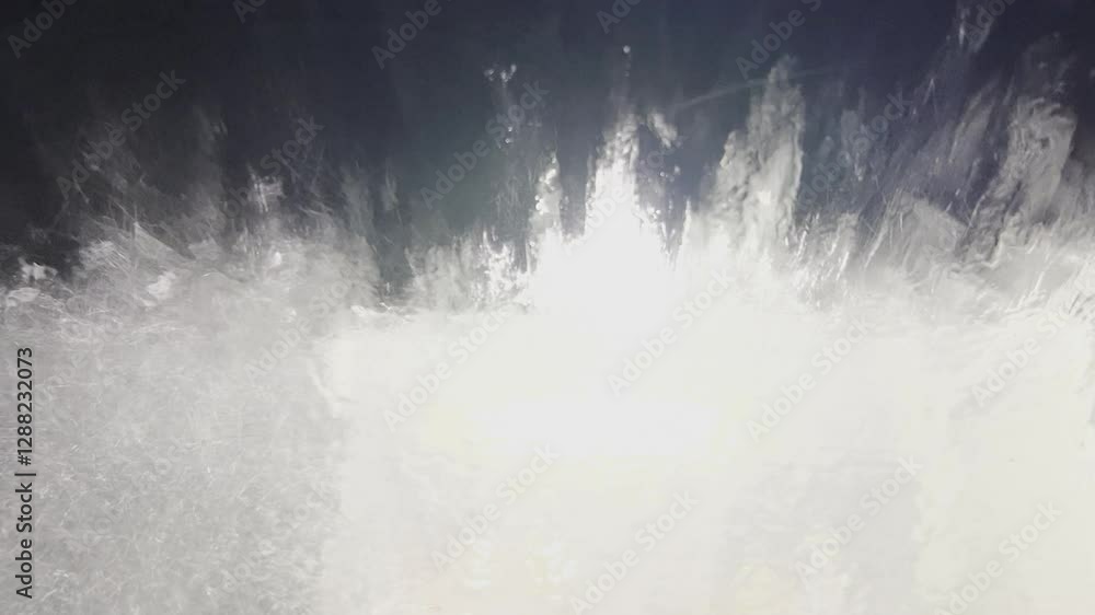 foam and water is running down the front window of a car, view from the driver seat in automatic car wash. Reset concept. Weird dream or fantasy concept foam and water is running down the front window of a car, view from the driver seat in automatic car wash. Reset concept. Weird dream or fantasy concept