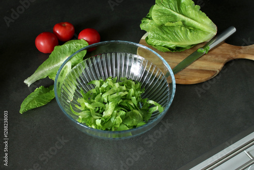 Top view of fresh green roman lettuce on wooden cutting board and in a bowl photo