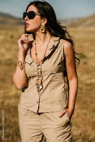 close up view of beautiful woman in dress holding necklace
