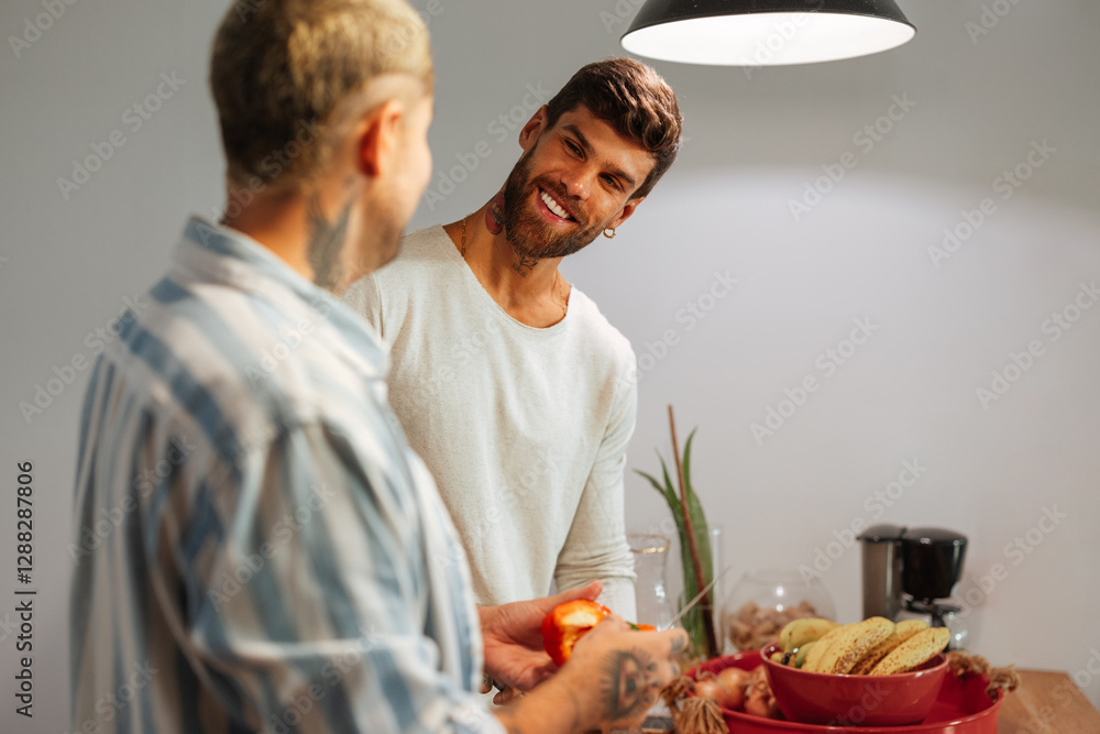 Happy gay couple in modern kitchen preparing healthy food together Happy gay couple in modern kitchen preparing healthy food together