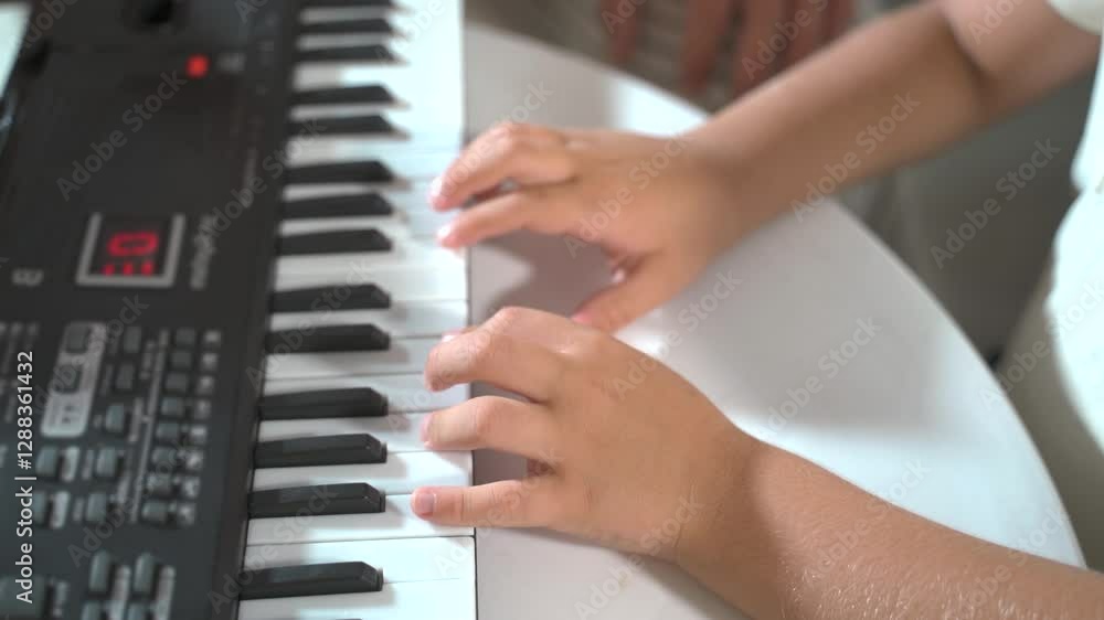 A boy kid hands, child plays the keys synthesizer piano