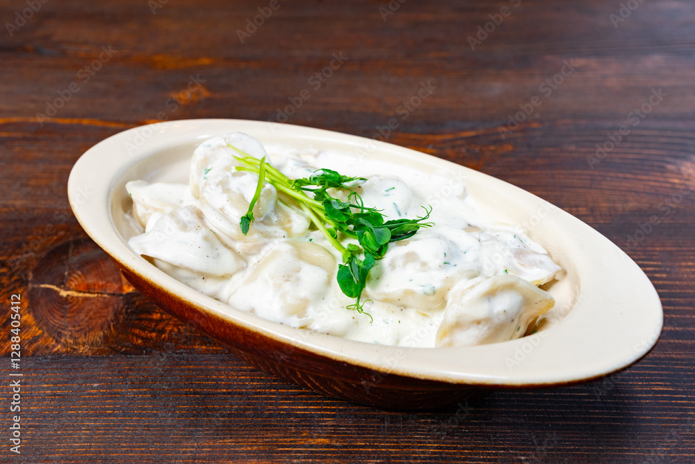 Delicious dumplings served in creamy sauce with garnish Delicious dumplings served in creamy sauce with garnish