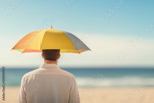 Man under colorful umbrella enjoys tranquil beach view and seren