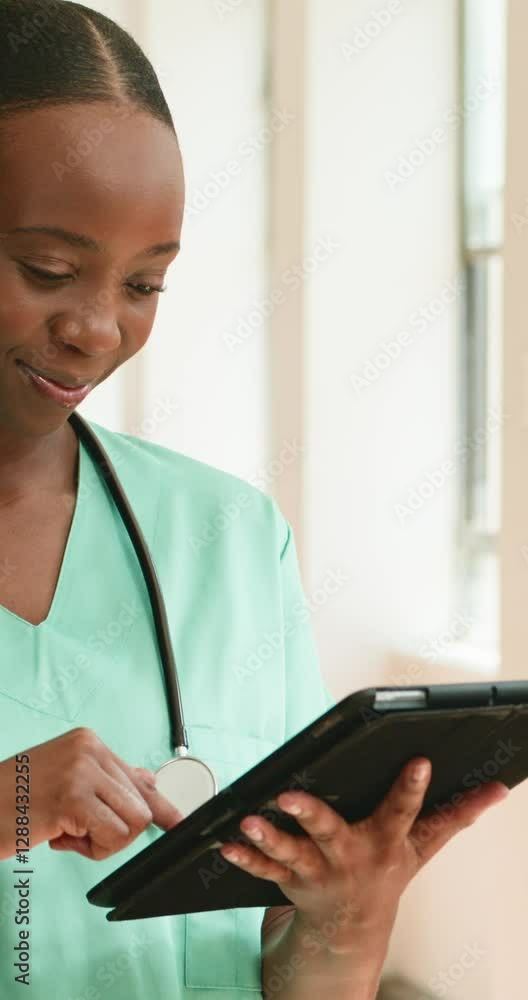 Smiling African American Nurse Using Tablet in Hospital Setting: Healthcare, Technology, and Wellness Smiling African American Nurse Using Tablet in Hospital Setting: Healthcare, Technology, and Wellness