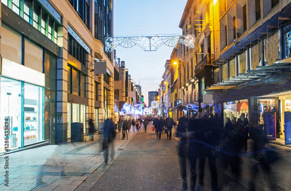 Pedestrianised 'Rue Neuve' shopping area of Brussels illuminated at twilight at christmas