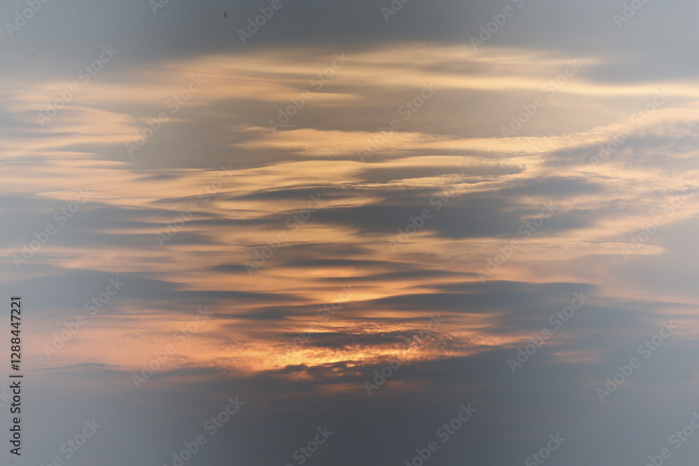 Fototapeta premium a sunset seen in the sky over a rice field in nakhon sawan province, north of bangkok on february 23, 2025..
