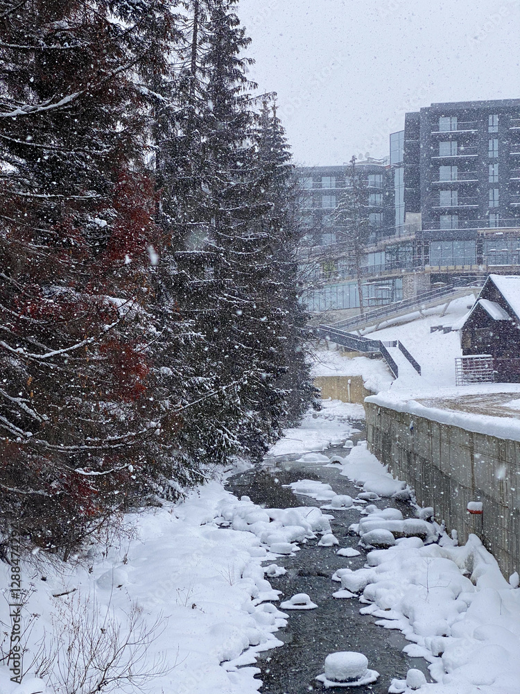 Snowy Stream and Modern Buildings in Winter