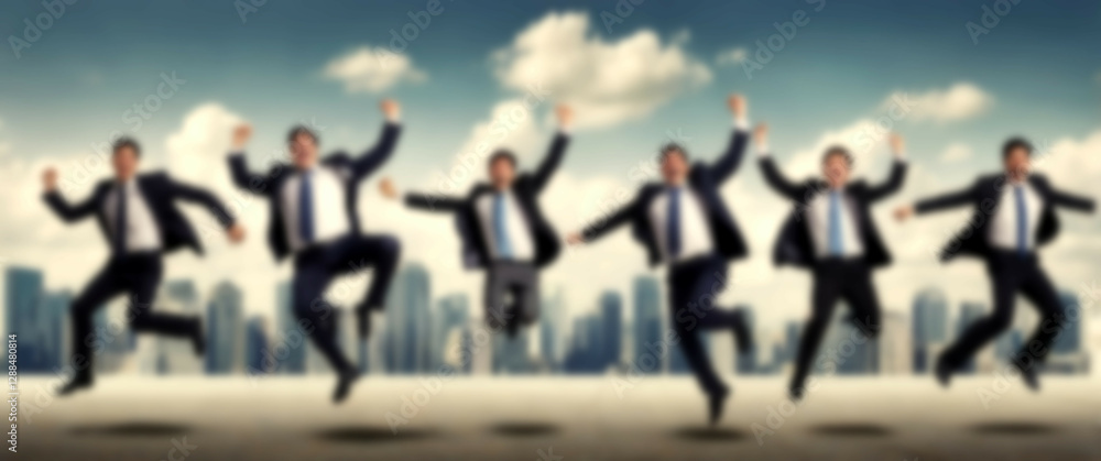 Blurred background depicting an ecstatic group of executives celebrating entrepreneurial triumph in unity Blurred background depicting an ecstatic group of executives celebrating entrepreneurial triumph in unity