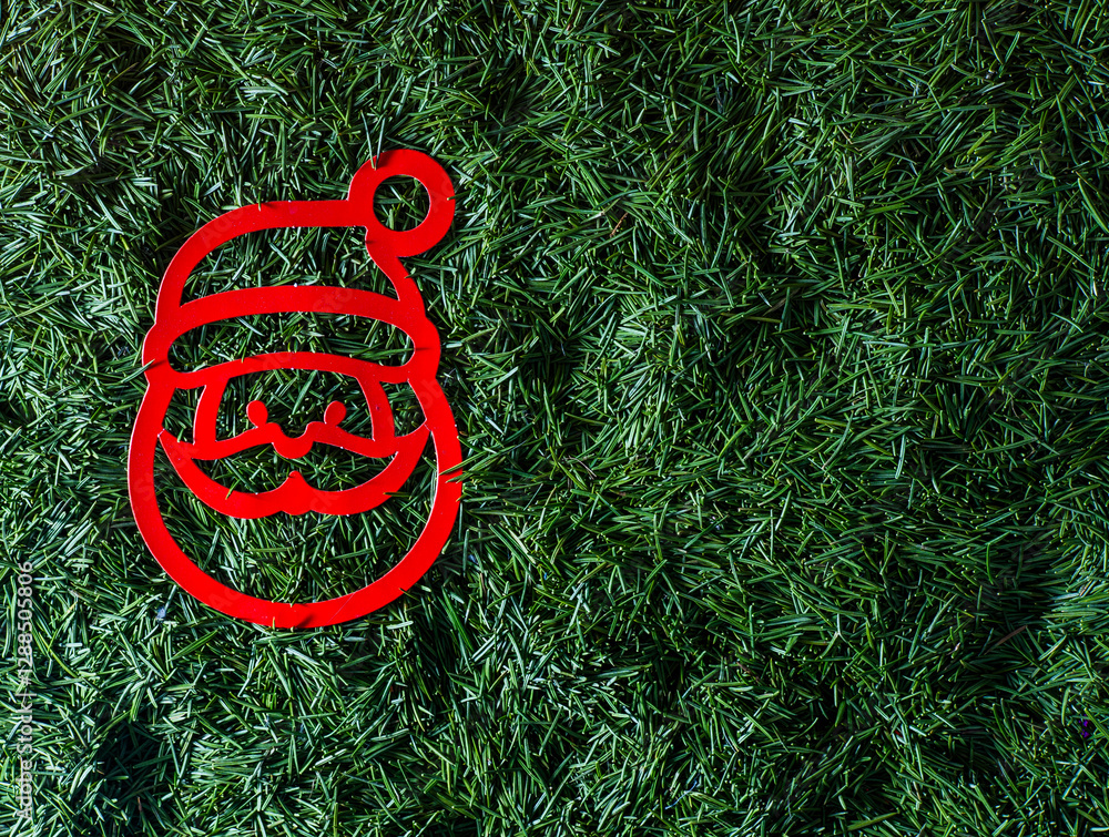 Red paper silhouette of Santa Claus decoration. Christmas tree toy with green needles in the background. Copy space. Red paper silhouette of Santa Claus decoration. Christmas tree toy with green needles in the background. Copy space.