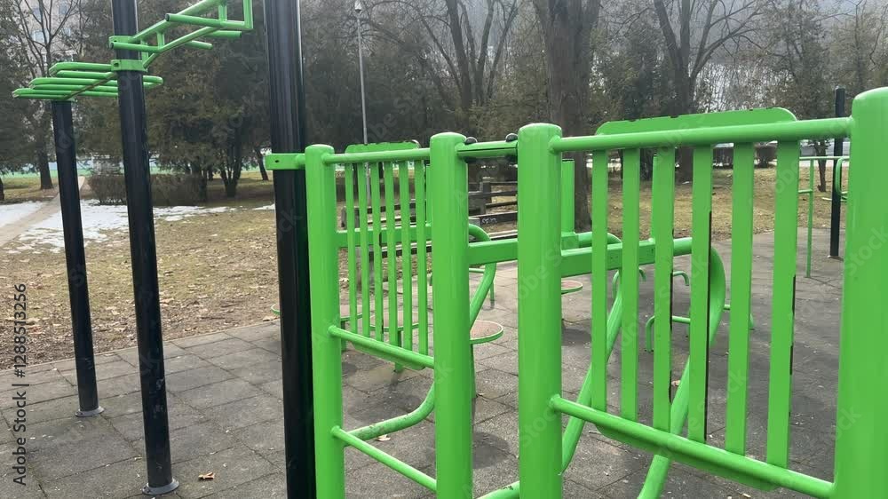 Green outdoor exercise equipment in a public park Green outdoor exercise equipment in a public park