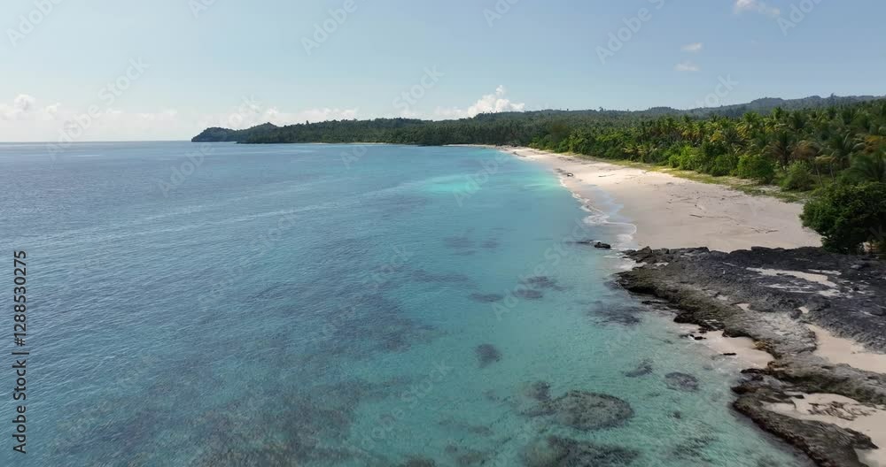 Aerial view & drone shot of a beautiful sand beach with palm trees and turquoise water by the ocean / September 2024: Pantai Poganda - Pulau Peleng - Sulawesi - Indonesia / 4K, UHD Aerial view & drone shot of a beautiful sand beach with palm trees and turquoise water by the ocean / September 2024: Pantai Poganda - Pulau Peleng - Sulawesi - Indonesia / 4K, UHD