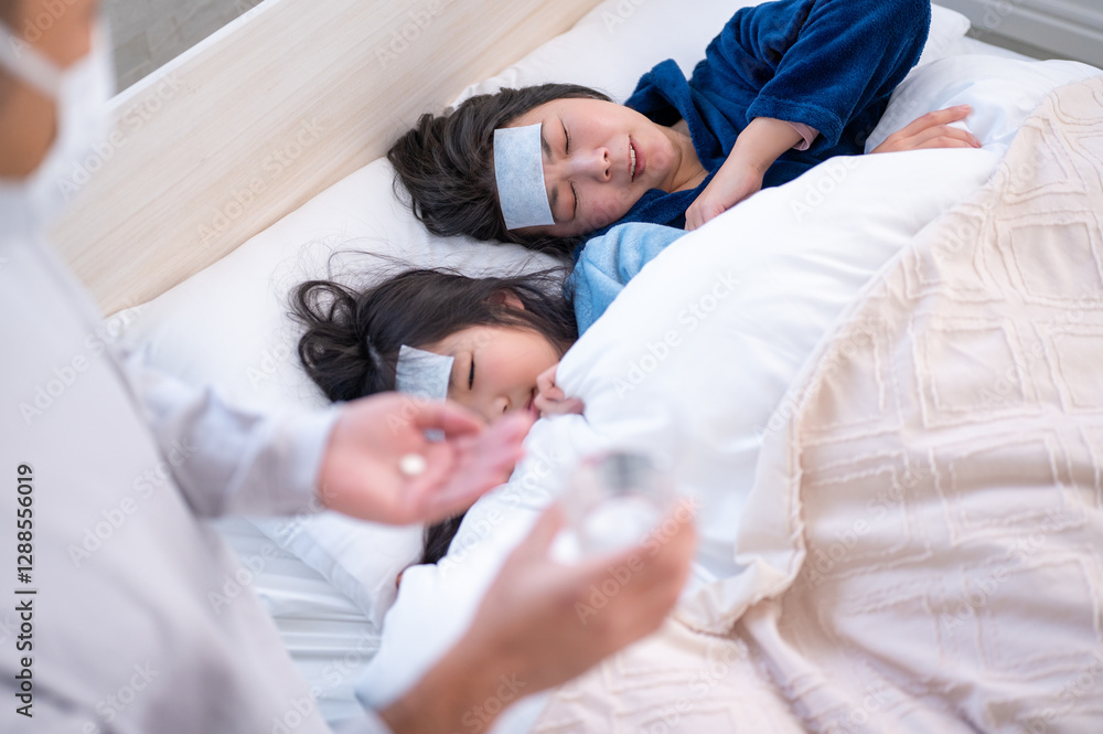 Obraz premium 病気の母子を看病する日本人男性