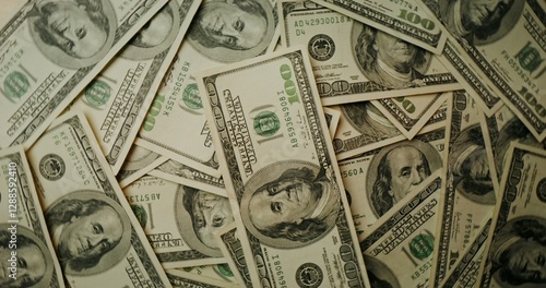 Fototapet Hundred dollar bills are scattered on the table