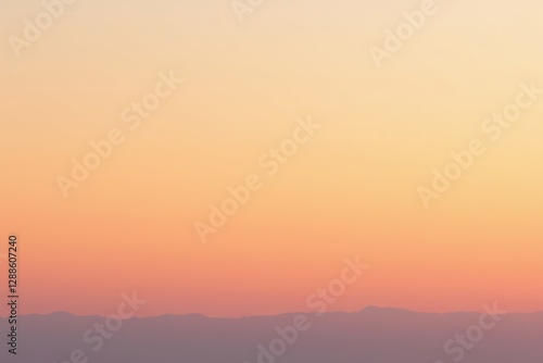 Serene Sunset Landscape Gentle Peach and Apricot Hues Over a Distant Mountain Range