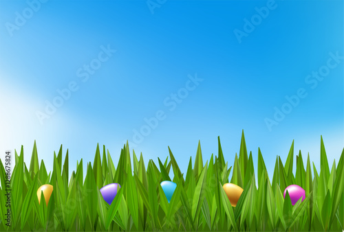 Colored chocolate eggs in green grass. Easter field with chocolates hunt. Spring meadow happy child holiday. Vector 3d banner border. Garden outdoors greeting, cute event gift concept. Blue cloudy sky