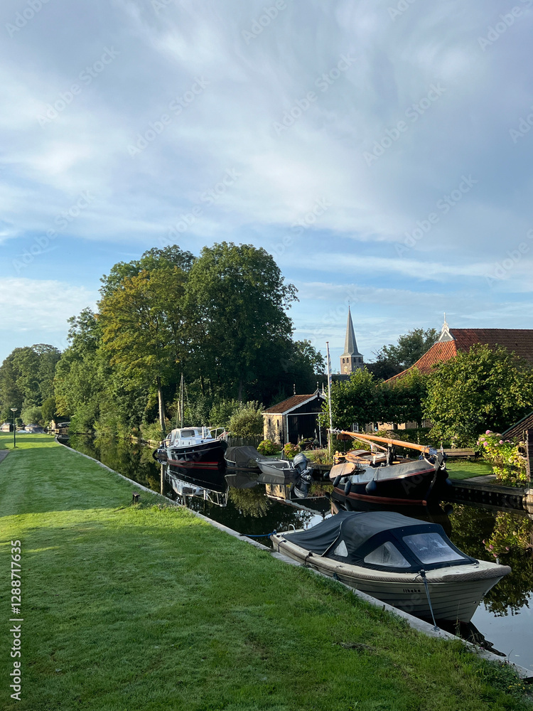 Canal with boats in IJlst in Friesland