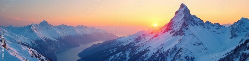 Fototapeta premium Snowy mountainscape with yellow-hued sky at sunset, cold, peaks covered in snow