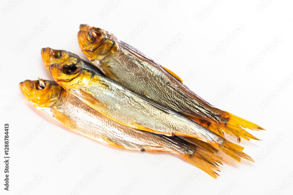 Hot smoked whole herrings on kitchen table. smoked fish isolated on white Hot smoked whole herrings on kitchen table. smoked fish isolated on white