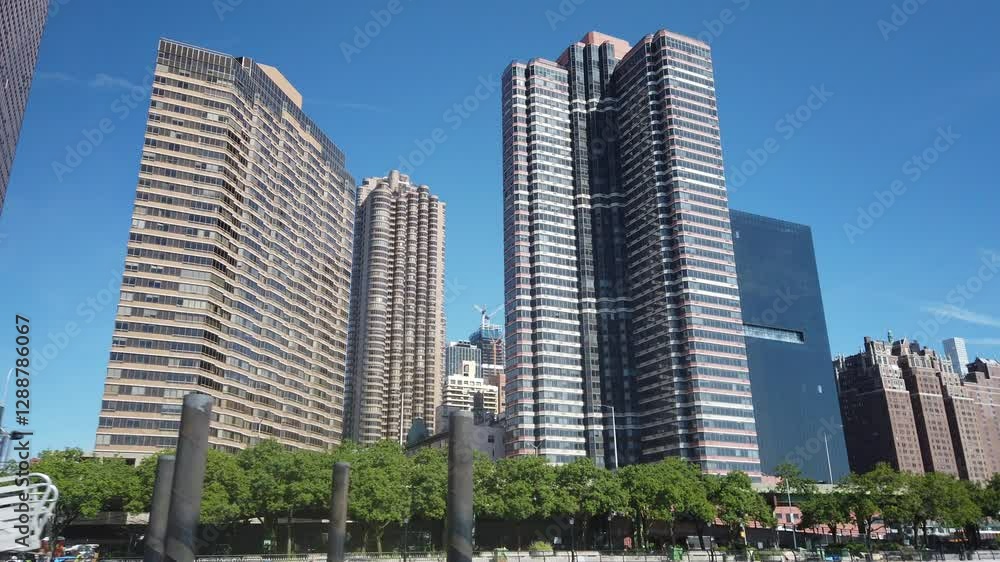 A view of upscale Manhattan apartment buildings as seen from the East River on a sunny summer day. A view of upscale Manhattan apartment buildings as seen from the East River on a sunny summer day.