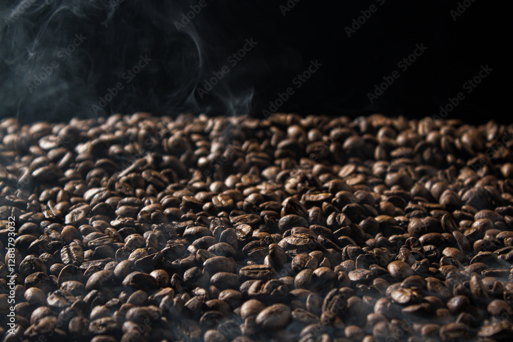 Fototapeta premium Freshly roasted coffee beans with smoke on black background